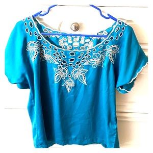 Blue flow-y blouse with a white flower embroidery